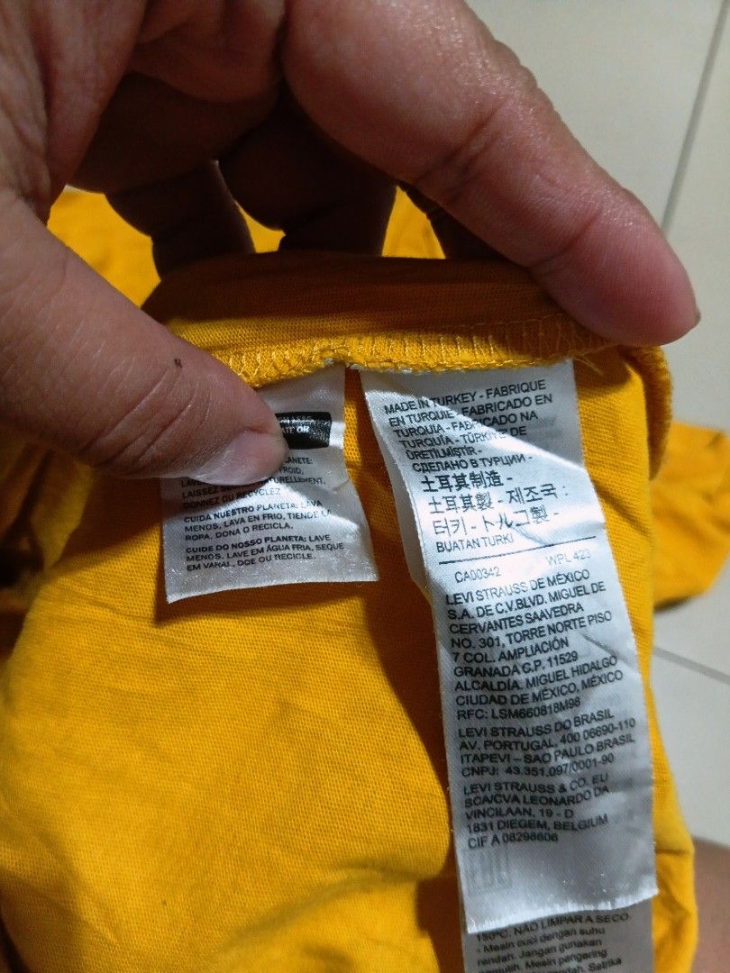 Lebays Yellow T-Shirt (Category: Tshirts & Polo Shirts ) located in Valenzuela. Submitted by AnahThrift (Listing ID 1469333393, Image 2). Description: - Brand: Lebays - Color: Bright yellow - Size: L (Measures 21" pit to pit by 28" length) - Design: Small logo on front, large woodgrain box logo graphic on the back - Details: Crew neck, short sleeves, made in Turkey - Condition: Clean fabric with tag attached near the collar.