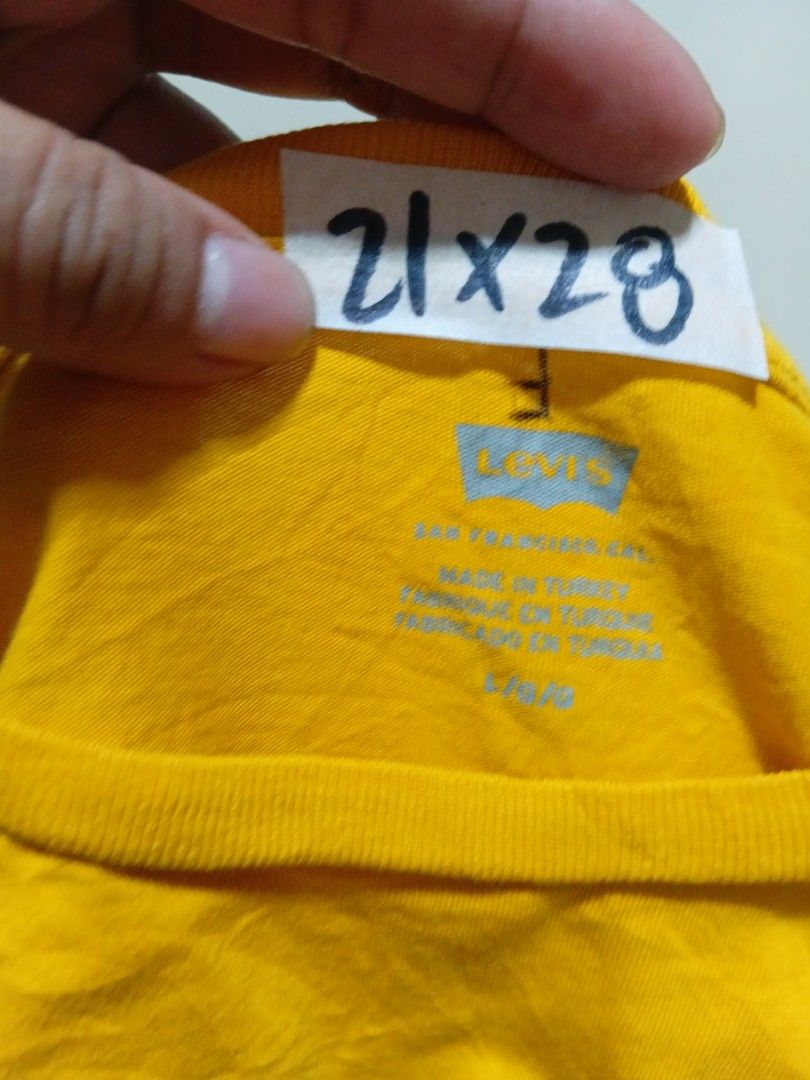 Lebays Yellow T-Shirt (Category: Tshirts & Polo Shirts ) located in Valenzuela. Submitted by AnahThrift (Listing ID 1469333393, Image 1). Description: - Brand: Lebays - Color: Bright yellow - Size: L (Measures 21" pit to pit by 28" length) - Design: Small logo on front, large woodgrain box logo graphic on the back - Details: Crew neck, short sleeves, made in Turkey - Condition: Clean fabric with tag attached near the collar.