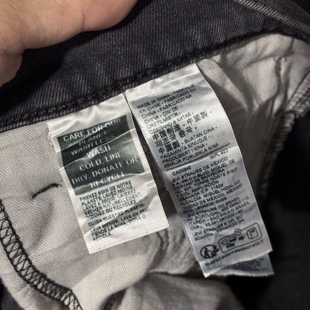 Levi's Denim Washed Black Jeans (Category: Jeans) located in Caloocan City. Submitted by bonsatocha43876 (Listing ID 1469327006, Image 3). Description: - Brand: Levi's - Color: Washed black - Fit: Relaxed through thighs with a classic straight leg - Waist: Mid rise with standard button and zipper fly - Pockets: Classic five-pocket styling with unique history print graphics inside - Details: Signature back pocket stitching and black leather back w