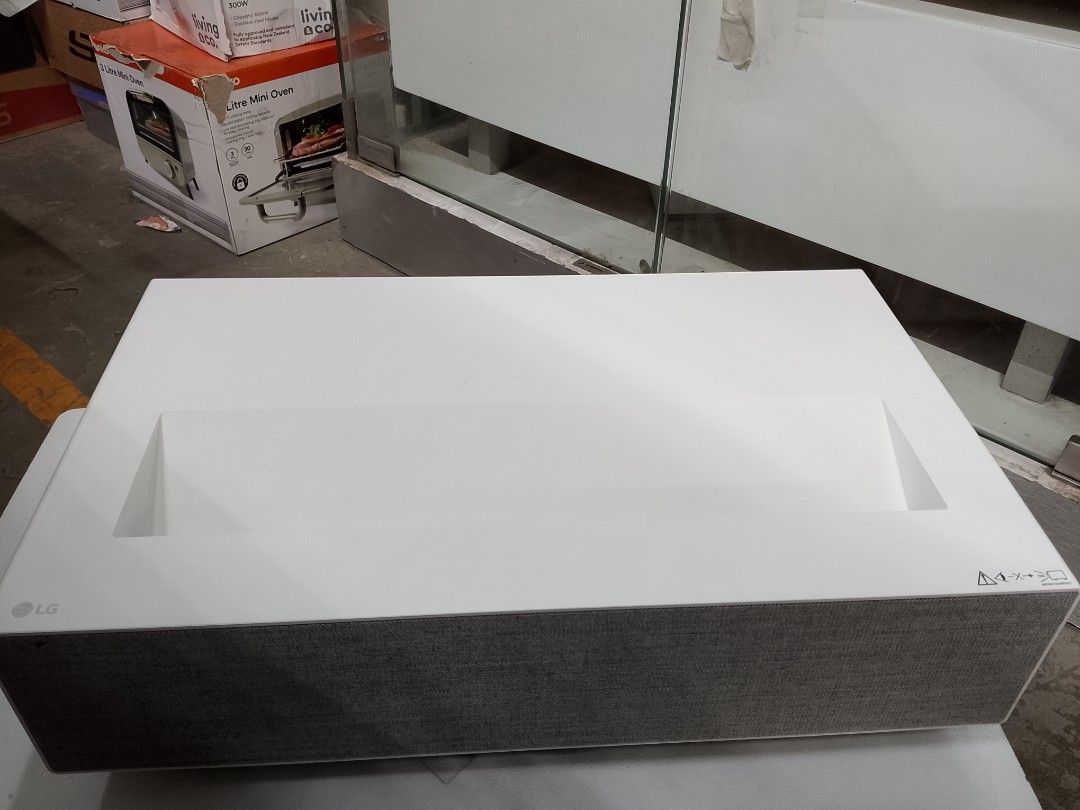 LG 4K UHD Ultra Short Throw Smart Laser Projector (Category: Projectors) located in Manila. Submitted by jlyn14 (Listing ID 1469203009, Image 1). Description: - Model: LG 4K UHD Ultra Short Throw Laser Projector (White) - Audio: Built-in speakers with stylish grey fabric mesh grille - Connectivity: Multiple HDMI ports, USB ports, optical audio out, and LAN port - Design: Clean, minimalist aesthetic requiring very little setup space - Performance: