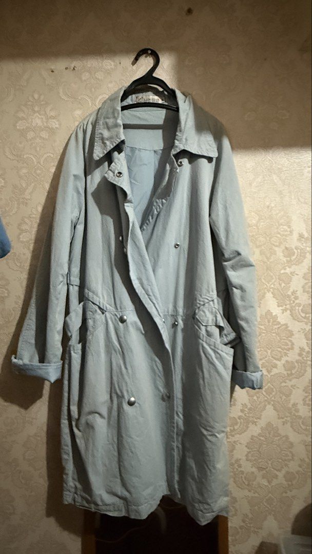 Light Blue Trench Coat Double Breasted (Category: Coats, Jackets and Outerwear) located in Cavite. Submitted by jcai03 (Listing ID 1469308695, Image 1). Description: - Color: Light blue with inner lining - Closure: Double-breasted snap buttons - Neckline & Cuffs: Classic collar and folded sleeves - Pockets: Two large front pockets - Fit: Adjustable drawstring waist for a gathered shape - Material: Lightweight and easy to wear.