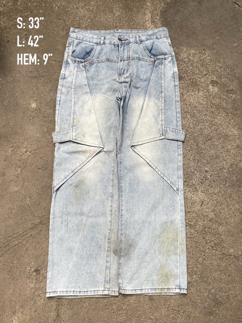 Light wash panel cargo denim jeans wide leg (Category: Jeans) located in Davao. Submitted by riab_qt (Listing ID 1469213853, Image 1). Description: - Style: Light wash wide-leg denim with unique geometric seams and paneled construction - Details: Cargo pockets, flap back pockets, and straight hem openings - Measurements: Waist 33", Length 42", Hem 9" - Condition: Shows minor signs of wear and slight fading throughout.