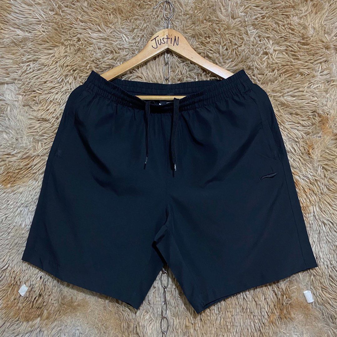 Li-Ning Black Athletic Shorts with Drawstring (Category: Shorts) located in Butuan. Submitted by jc13thrifts (Listing ID 1469341485, Image 1). Description: - Brand: Li-Ning - Color: Classic black - Material: Lightweight and breathable fabric, perfect for gym or casual days - Waistband: Elastic with matching black drawstrings and branded tips - Closure: Front zippered fly - Branding: Subtle Li-Ning logo stamped on the left leg.