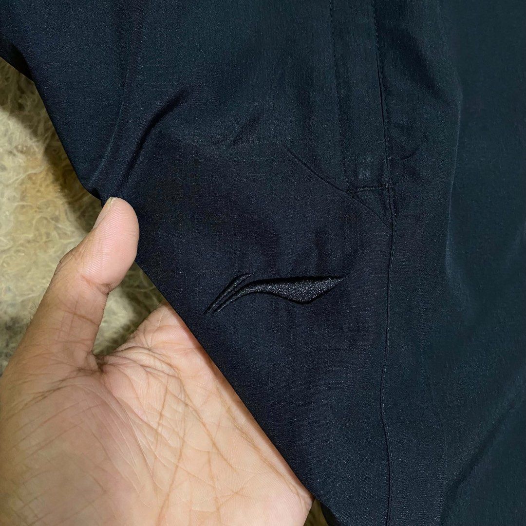 Li-Ning Black Athletic Shorts with Drawstring (Category: Shorts) located in Butuan. Submitted by jc13thrifts (Listing ID 1469341485, Image 3). Description: - Brand: Li-Ning - Color: Classic black - Material: Lightweight and breathable fabric, perfect for gym or casual days - Waistband: Elastic with matching black drawstrings and branded tips - Closure: Front zippered fly - Branding: Subtle Li-Ning logo stamped on the left leg.