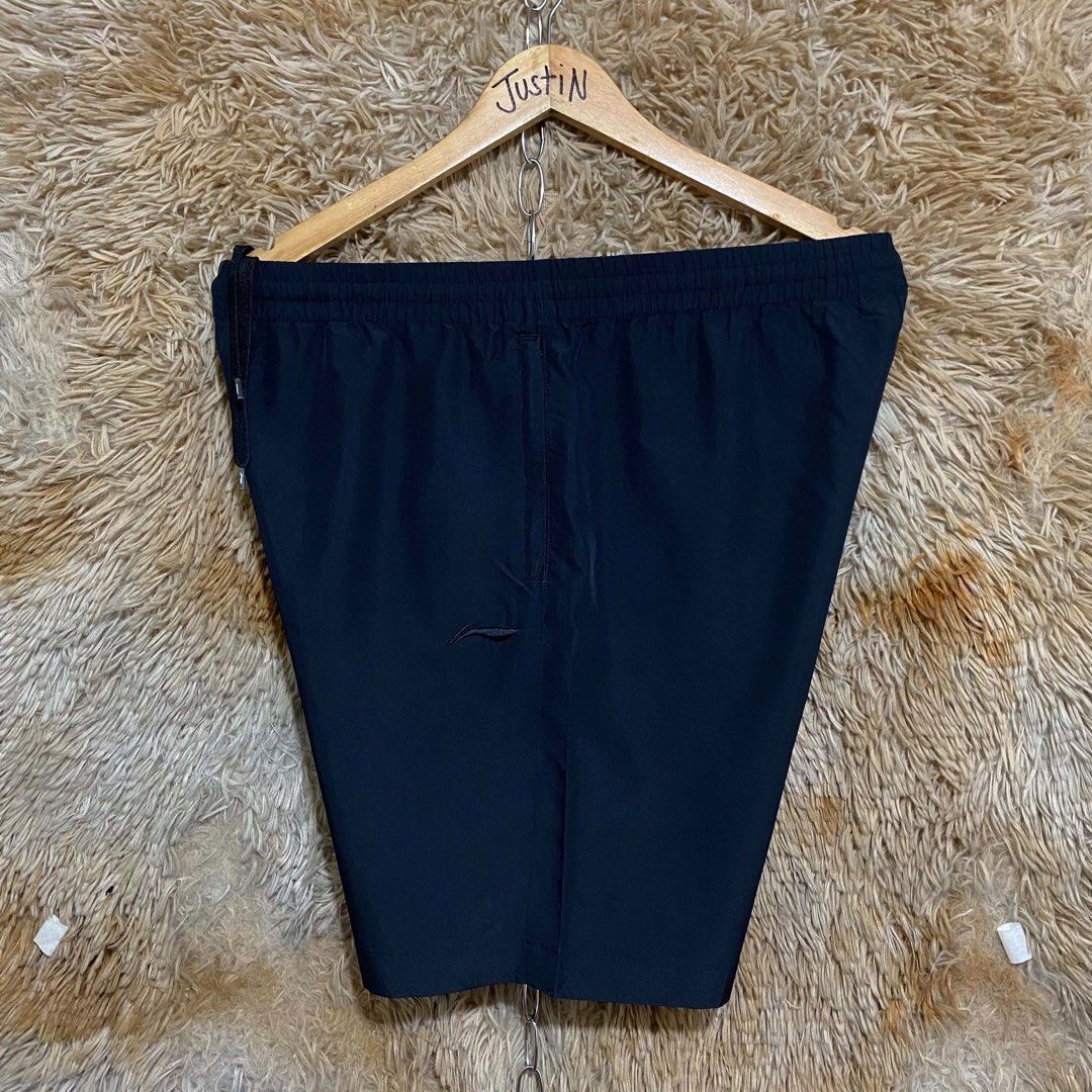 Li-Ning Black Athletic Shorts with Drawstring (Category: Shorts) located in Butuan. Submitted by jc13thrifts (Listing ID 1469341485, Image 2). Description: - Brand: Li-Ning - Color: Classic black - Material: Lightweight and breathable fabric, perfect for gym or casual days - Waistband: Elastic with matching black drawstrings and branded tips - Closure: Front zippered fly - Branding: Subtle Li-Ning logo stamped on the left leg.