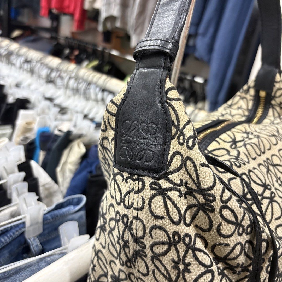 Loewe Cubi Anagram Bag Ecru (Category: Shoulder Bags) located in Zamboanga. Submitted by thriftyyali (Listing ID 1469256570, Image 2). Description: - Authentic Loewe shoulder bag - Iconic beige and black Anagram monogram canvas - Premium black leather strap and trim - Secure gold-tone zipper closure with Loewe engraved pull - Herringbone fabric interior lining with leather brand tag - Flaw: Minor blue ink marks inside the lining near the bottom -