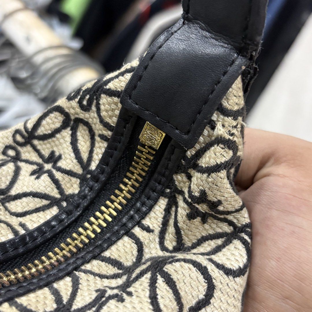 Loewe Cubi Anagram Bag Ecru (Category: Shoulder Bags) located in Zamboanga. Submitted by thriftyyali (Listing ID 1469256570, Image 3). Description: - Authentic Loewe shoulder bag - Iconic beige and black Anagram monogram canvas - Premium black leather strap and trim - Secure gold-tone zipper closure with Loewe engraved pull - Herringbone fabric interior lining with leather brand tag - Flaw: Minor blue ink marks inside the lining near the bottom -