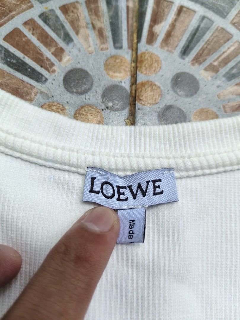 Loewe Ribbed Tank Top White Size M (Category: Sleeveless) located in Quezon. Submitted by miksxthrift (Listing ID 1469275469, Image 2). Description: - Authentic Loewe ribbed tank top in pristine condition (tags attached) - Size: M - Color: White - Material: 100% cotton main fabric with stylish polyester embroidery - Made in Portugal - Features: Classic scoop neck and embroidered Loewe anagram logo on the chest - Product Code: S848341X02 - Clean n