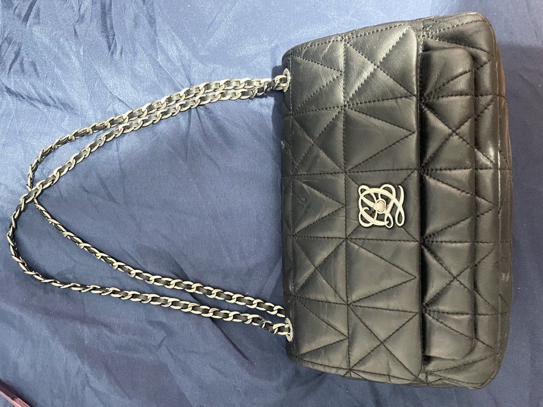 Loius Quatorze Quilted Black Leather Shoulder Bag (Category: Luxury Bags & Wallets) located in Manila. Submitted by abeline07 (Listing ID 1469296483, Image 3). Description: Black quilted leather shoulder bag . Unique triangular geometric stitching pattern across the body. Silver tone chain strap intertwined with black leather. Distinctive silver interlocking anagram turn-lock closure on the front flap. Structured rectangular shape with reinforced