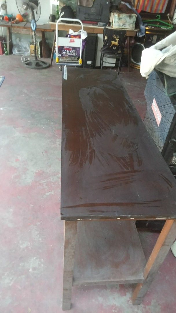 Long Wooden Side Table with Lower Shelf (Category: Tables & Sets) located in Quezon City. Submitted by madelrivera (Listing ID 1469275062, Image 1). Description: - Long wooden side table with dark brown top and lighter wooden legs - Features a lower storage shelf for extra organization - Sturdy build, perfect for entryways, living rooms, or garages - Condition: Shows surface marks and wear from previous use - DM if interested or for more photos.