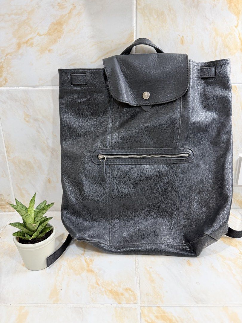 Longchamp Black Leather Backpack (Category: Backpacks) located in Manila. Submitted by haveago0dthrift (Listing ID 1469256246, Image 1). Description: - Brand: Longchamp - Material: Soft pebbled leather with dark hardware - Color: Classic Black - Closure: Top flap with snap button and embossed logo - Pockets: Exterior zipped front pocket and interior open slip pocket - Straps: Adjustable fabric straps with top grab handle - Interior: Signature jac