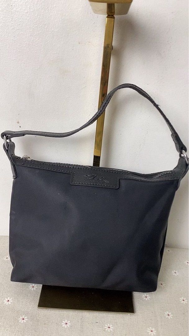 Longchamp Black Nylon Handbag (Category: Luxury Bags & Wallets) located in Mandaluyong City. Submitted by gentle.segoviajam (Listing ID 1469321419, Image 1). Description: Classic black Longchamp nylon handbag with leather strap and zipper closure. Compact and versatile for everyday use. Message for details!.