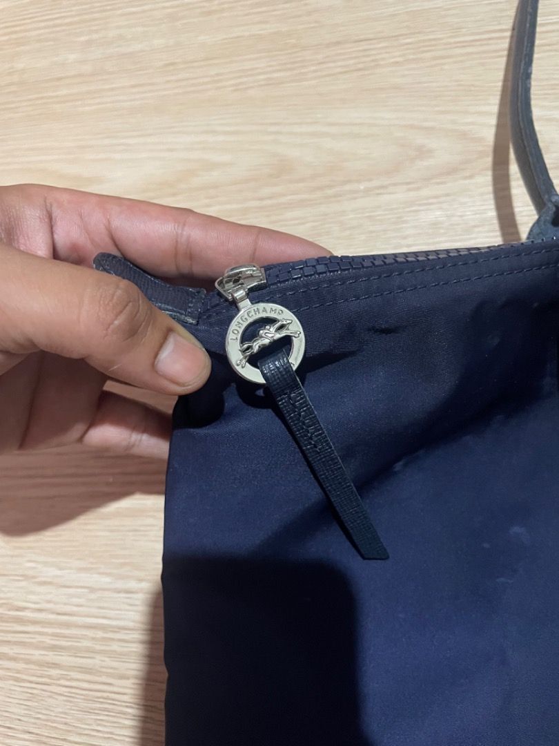 Longchamp Le Pliage Navy Blue Tote Bag (Category: Luxury Bags & Wallets) located in Sorsogon. Submitted by solayram0114595 (Listing ID 1469215360, Image 3). Description: - Brand: Longchamp Le Pliage - Color: Classic Navy Blue with dark leather trim - Style: Shoulder bag with comfortable long straps - Material: Lightweight nylon body and durable leather flap/handles - Hardware: Silver-tone zipper with iconic jockey logo - Interior: Clean lining wi
