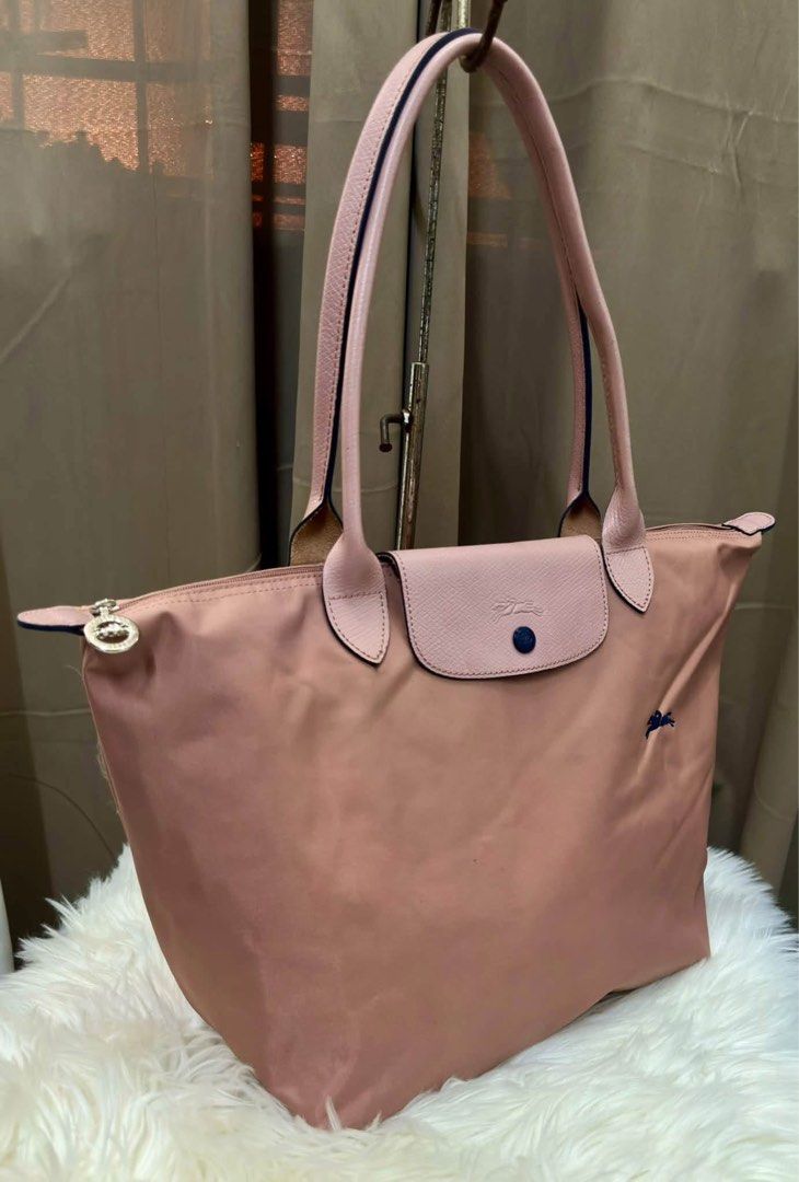 Longchamp Le Pliage Pink Tote Bag (Category: Luxury Bags & Wallets) located in Lipa City. Submitted by thyra06 (Listing ID 1469290268, Image 3). Description: - Authentic Longchamp Le Pliage shoulder bag - Color: Lovely pink with matching leather handles and flap - Material: Durable nylon body with crisp hardware snaps - Features: Secure zip top with branded pull tab and signature embroidered horse logo - Condition: Clean interior and well-maintai