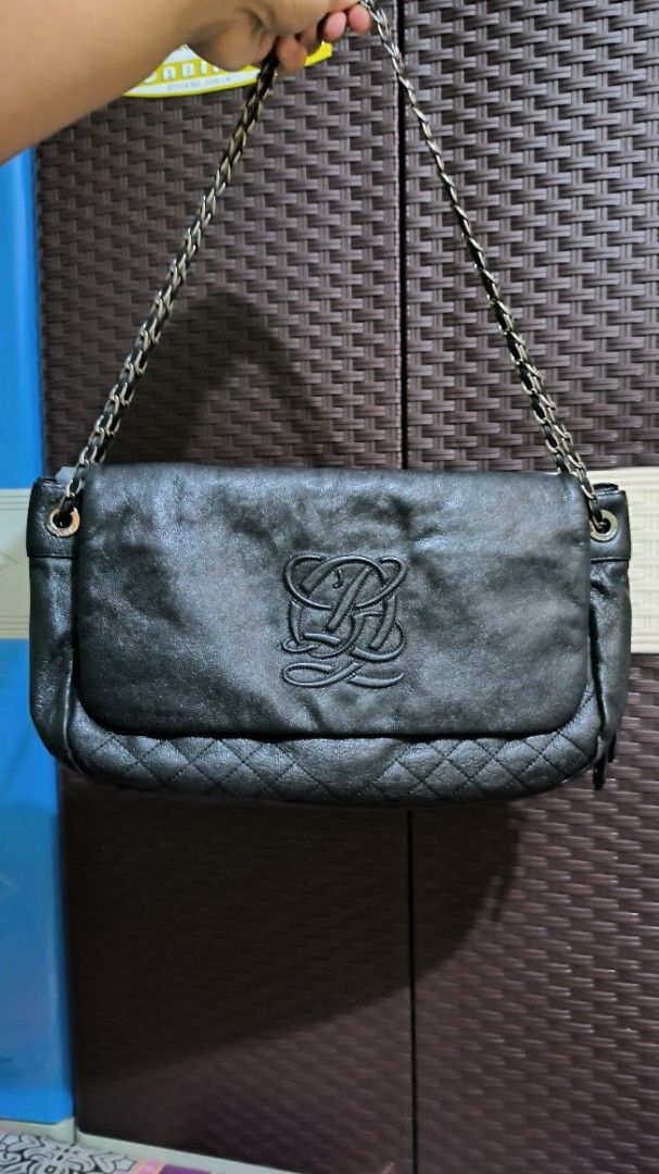 Louis Quatorze Black Leather Chain Shoulder Bag (Category: Purses & Pouches) located in Quezon City. Submitted by 88bagelya_ni_rhen88 (Listing ID 1469361539, Image 1). Description: - Brand: Louis Quatorze - Color: Classic Black - Material: Premium Leather - Design: Flap closure with stylish quilted pattern at the bottom edge and subtle debossed logo - Strap: Chic chain shoulder strap with metal links - Interior: Monogram-lined fabric with zip poc