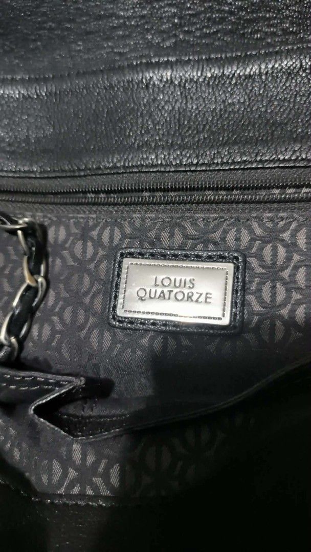 Louis Quatorze Black Leather Chain Shoulder Bag (Category: Purses & Pouches) located in Quezon City. Submitted by 88bagelya_ni_rhen88 (Listing ID 1469361539, Image 2). Description: - Brand: Louis Quatorze - Color: Classic Black - Material: Premium Leather - Design: Flap closure with stylish quilted pattern at the bottom edge and subtle debossed logo - Strap: Chic chain shoulder strap with metal links - Interior: Monogram-lined fabric with zip poc