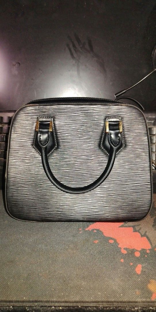 Louis Vuitton Black Epi Leather Handbag (Category: Luxury Bags & Wallets) located in Manila. Submitted by chuaniki (Listing ID 1469304191, Image 2). Description: - Brand: Louis Vuitton - Material: Durable black Epi leather with gold-tone hardware - Design: Structured top handle bag with dual rolled handles - Closure: Secure top zipper closure - Interior: Black fabric lining with an LV-stamped zippered pocket compartment - Condition: Excellent, cl