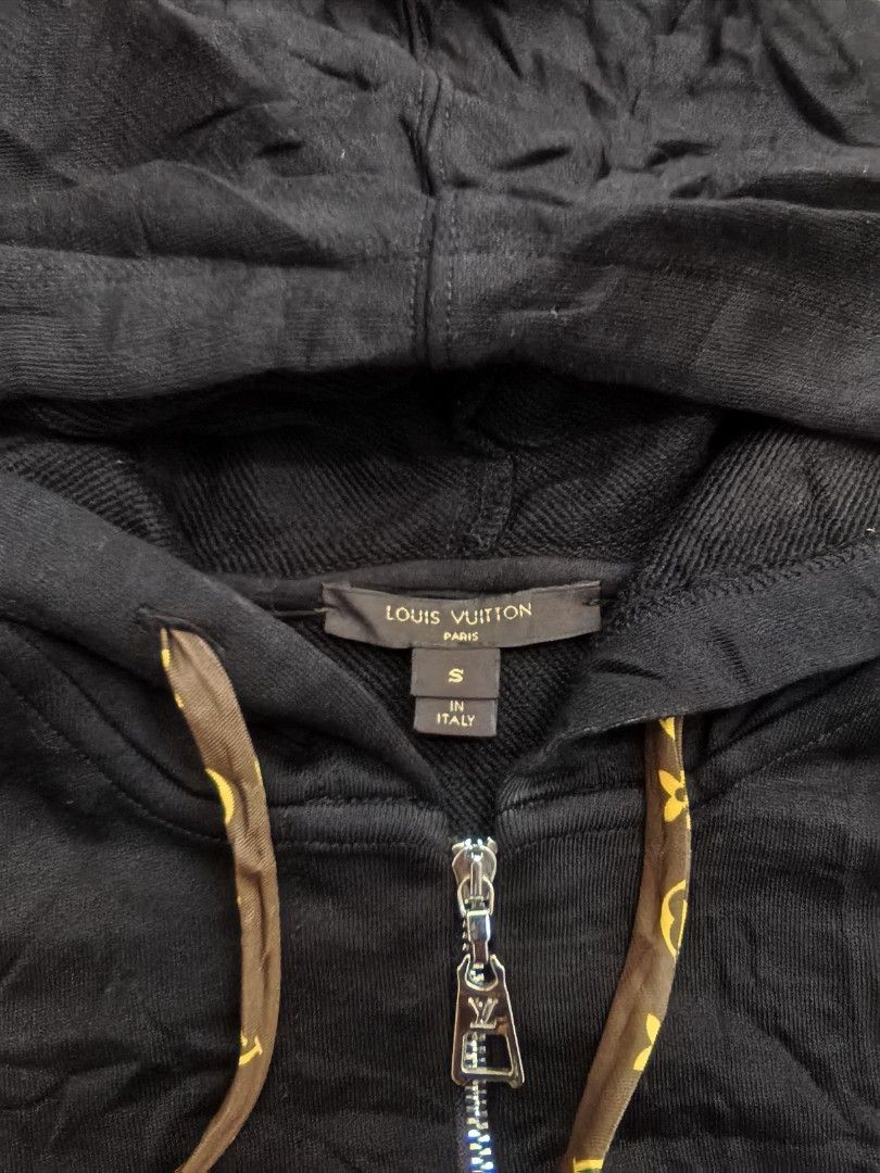 Louis Vuitton Black Monogram Drawstring Zip Hoodie (Category: Hoodies) located in Quezon. Submitted by miksxthrift (Listing ID 1469276315, Image 2). Description: - Brand: Louis Vuitton - Item: Black Zip Hoodie - Size: S (Regular Fit) - Material: 80% Cotton, 20% Polyester (Made in Italy) - Design details: Monogram pattern on drawstrings, pocket linings, and inside hood - Hardware: Full metal zipper with LV pull tab - Care: Gentle dry clean only - 