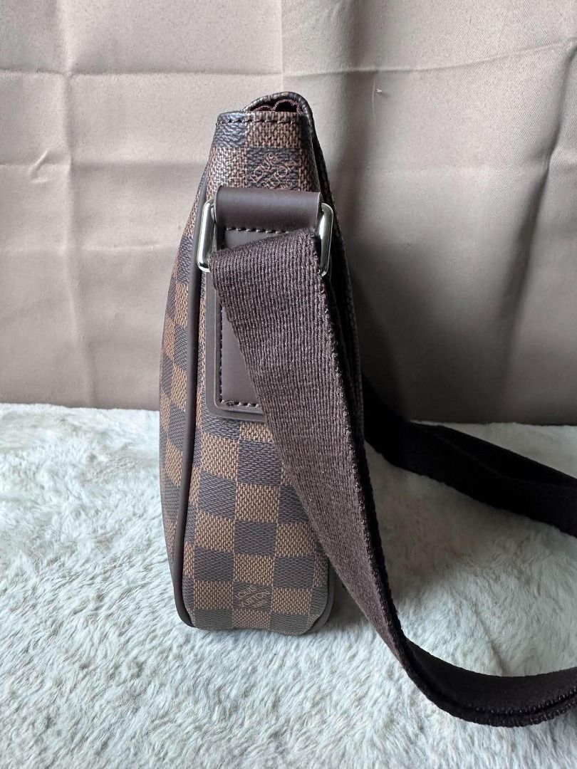 Louis Vuitton Damier Ebene Messenger Bag (Category: Luxury Bags & Wallets) located in Davao. Submitted by luckyturtle.aa6ccf (Listing ID 1469273292, Image 3). Description: - Authentic Louis Vuitton messenger bag in Damier Ebene canvas - Classic brown checkered pattern with dark brown leather trim - Adjustable canvas shoulder strap and silver-tone hardware - Clean burgundy fabric interior with Louis Vuitton Paris heat stamp - Great everyday crossb