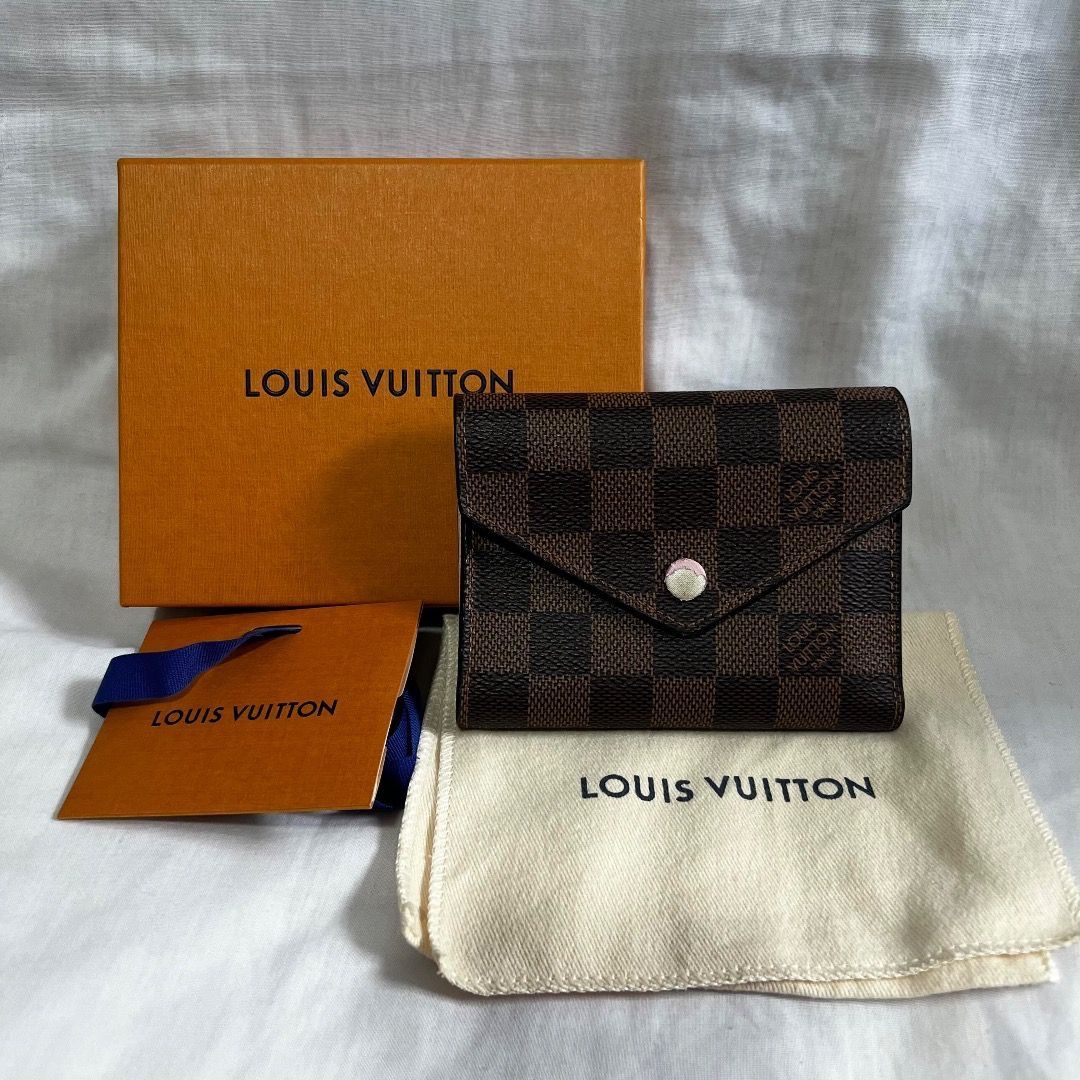 Louis Vuitton Damier Ebene Wallet (Category: Luxury Bags & Wallets) located in Quezon City. Submitted by _declutteringmom (Listing ID 1469305703, Image 1). Description: ✨ Louis Vuitton Victorine - Damier Ebene, Rose Ballerine interior ✨ 💯 guaranteed authentic 👜 Bought from LV Greenbelt ➡️ With dust bag, box, lace ➡️ Condition: lightly used; only flaw is the front button 💰 Mode of payment: BPI, GCash, GoTyme.