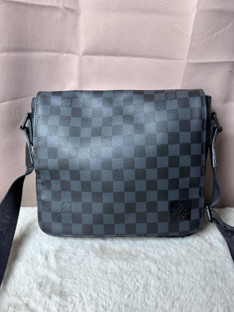Louis Vuitton Damier Graphite District PM Messenger Bag (Category: Luxury Bags & Wallets) located in Davao. Submitted by luckyturtle.aa6ccf (Listing ID 1469273460, Image 2). Description: - Authentic Louis Vuitton messenger bag in iconic Damier Graphite canvas (dark grey and black) - Adjustable black fabric strap with woven Louis Vuitton lettering - Secure flap closure design with sleek black hardware - Clean interior fabric lining featuring an op