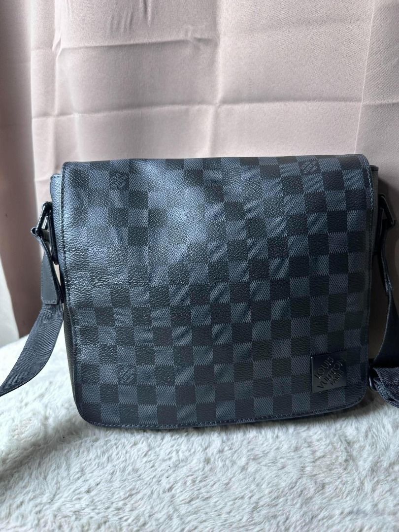 Louis Vuitton Damier Graphite District PM Messenger Bag (Category: Luxury Bags & Wallets) located in Davao. Submitted by luckyturtle.aa6ccf (Listing ID 1469273460, Image 3). Description: - Authentic Louis Vuitton messenger bag in iconic Damier Graphite canvas (dark grey and black) - Adjustable black fabric strap with woven Louis Vuitton lettering - Secure flap closure design with sleek black hardware - Clean interior fabric lining featuring an op
