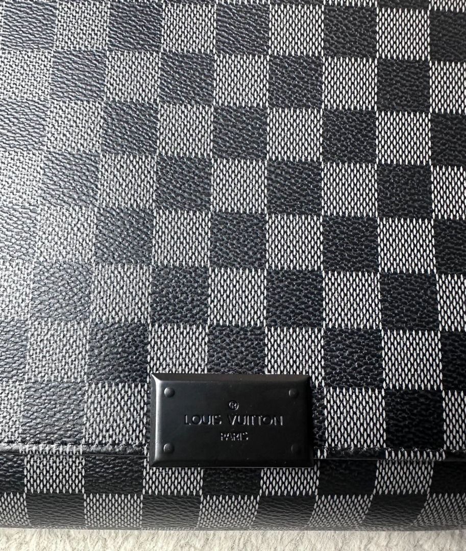Louis Vuitton Damier Graphite Messenger Bag (Category: Luxury Bags & Wallets) located in Davao. Submitted by luckyturtle.aa6ccf (Listing ID 1469274259, Image 3). Description: - Brand: Louis Vuitton - Design: Black and grey checker pattern monogram canvas with front metal brand plate - Strap: Wide black fabric adjustable shoulder strap with silver hardware - Style: Compact everyday crossbody bag with structured rectangular profile and clean stitch