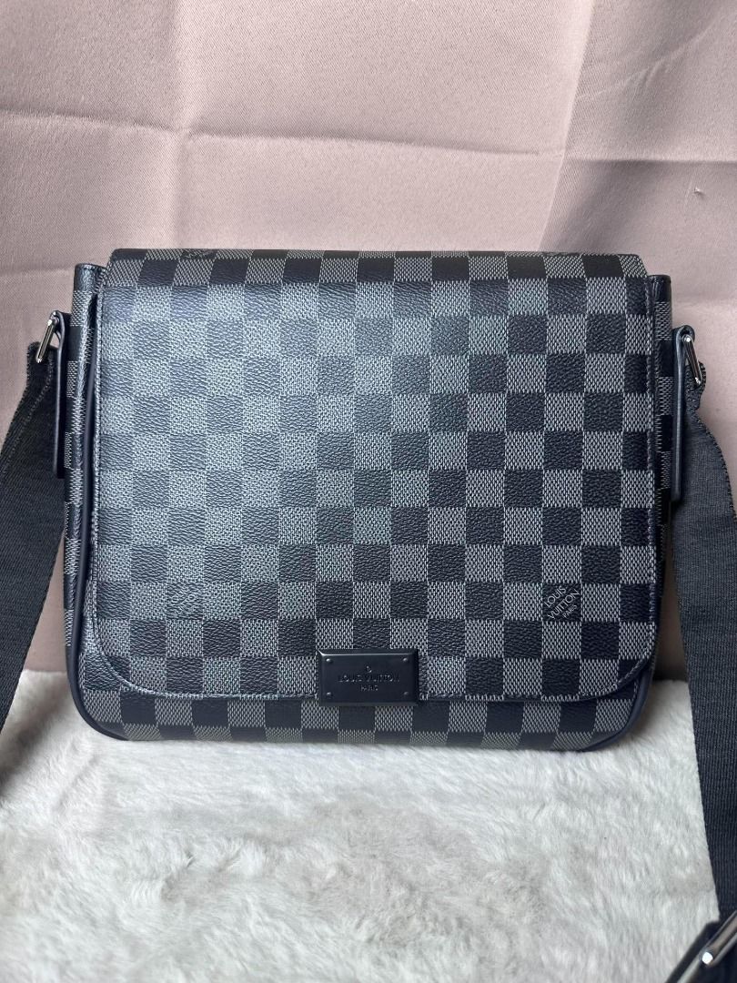 Louis Vuitton Damier Graphite Messenger Bag (Category: Luxury Bags & Wallets) located in Davao. Submitted by luckyturtle.aa6ccf (Listing ID 1469274259, Image 2). Description: - Brand: Louis Vuitton - Design: Black and grey checker pattern monogram canvas with front metal brand plate - Strap: Wide black fabric adjustable shoulder strap with silver hardware - Style: Compact everyday crossbody bag with structured rectangular profile and clean stitch