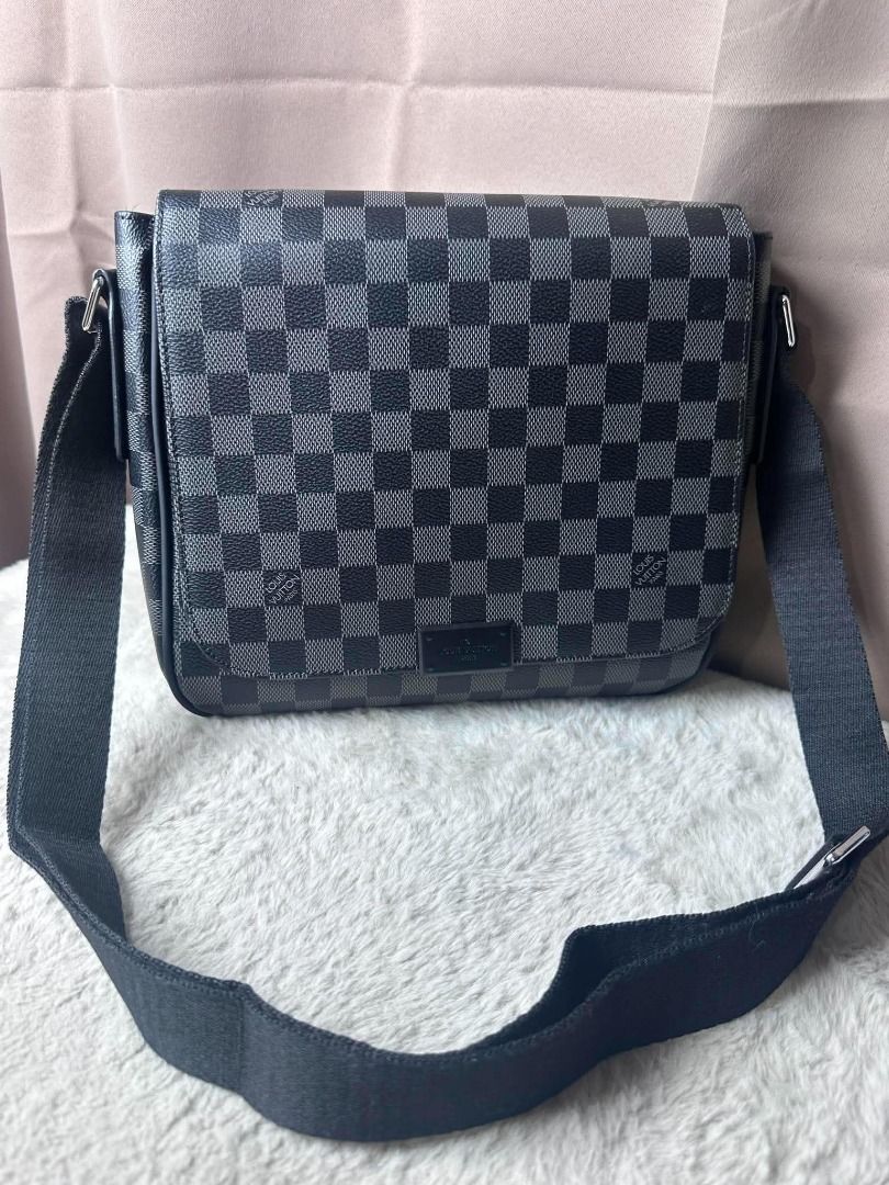 Louis Vuitton Damier Graphite Messenger Bag (Category: Luxury Bags & Wallets) located in Davao. Submitted by luckyturtle.aa6ccf (Listing ID 1469274259, Image 1). Description: - Brand: Louis Vuitton - Design: Black and grey checker pattern monogram canvas with front metal brand plate - Strap: Wide black fabric adjustable shoulder strap with silver hardware - Style: Compact everyday crossbody bag with structured rectangular profile and clean stitch