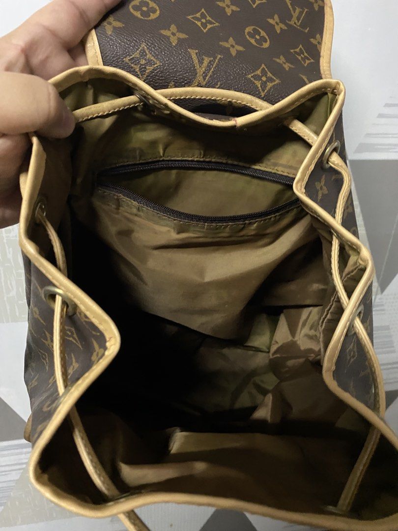 Louis Vuitton Monogram Backpack (Category: Luxury Bags & Wallets) located in Quezon City. Submitted by natesm (Listing ID 1469314367, Image 3). Description: - Authentic Louis Vuitton monogram canvas backpack with classic vachetta leather trim - Adjustable brown textile web straps with metal hardware - Secure front flap closure featuring a buckle strap and drawstring - Dual exterior front pockets with flap closures for easy access - Brown fabric-l