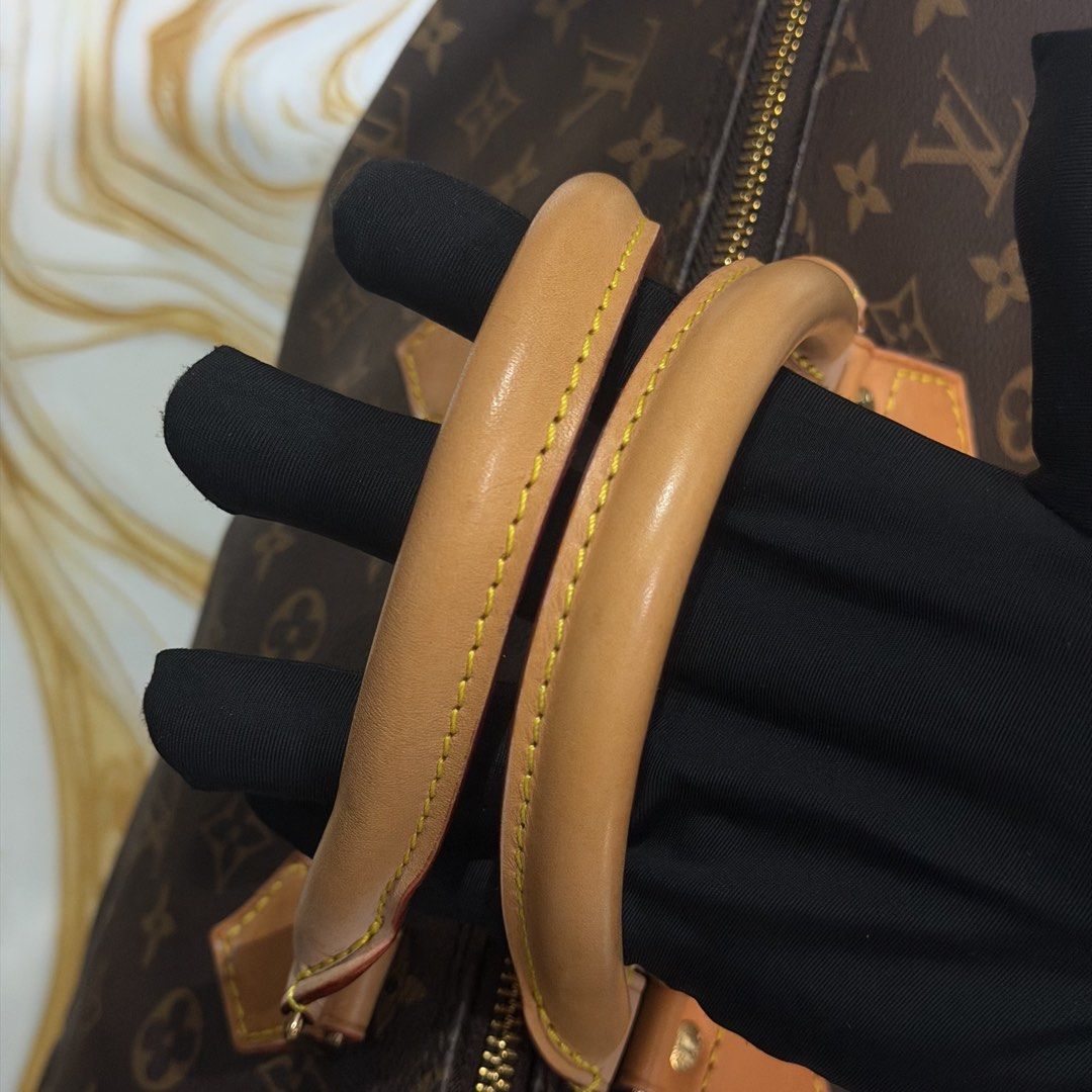 Louis Vuitton Monogram Canvas Speedy 30 Handbag (Category: Luxury Bags & Wallets) located in Bambang. Submitted by heats777 (Listing ID 1469170418, Image 2). Description: Classic Monogram canvas exterior with natural cowhide leather trim. Double rolled top handles, gold-tone hardware, and brown textile lining. Heat stamp reads Louis Vuitton Paris Made in France. Interior leather tab shows model code M41524. Zip closure across the top. Clean stitc