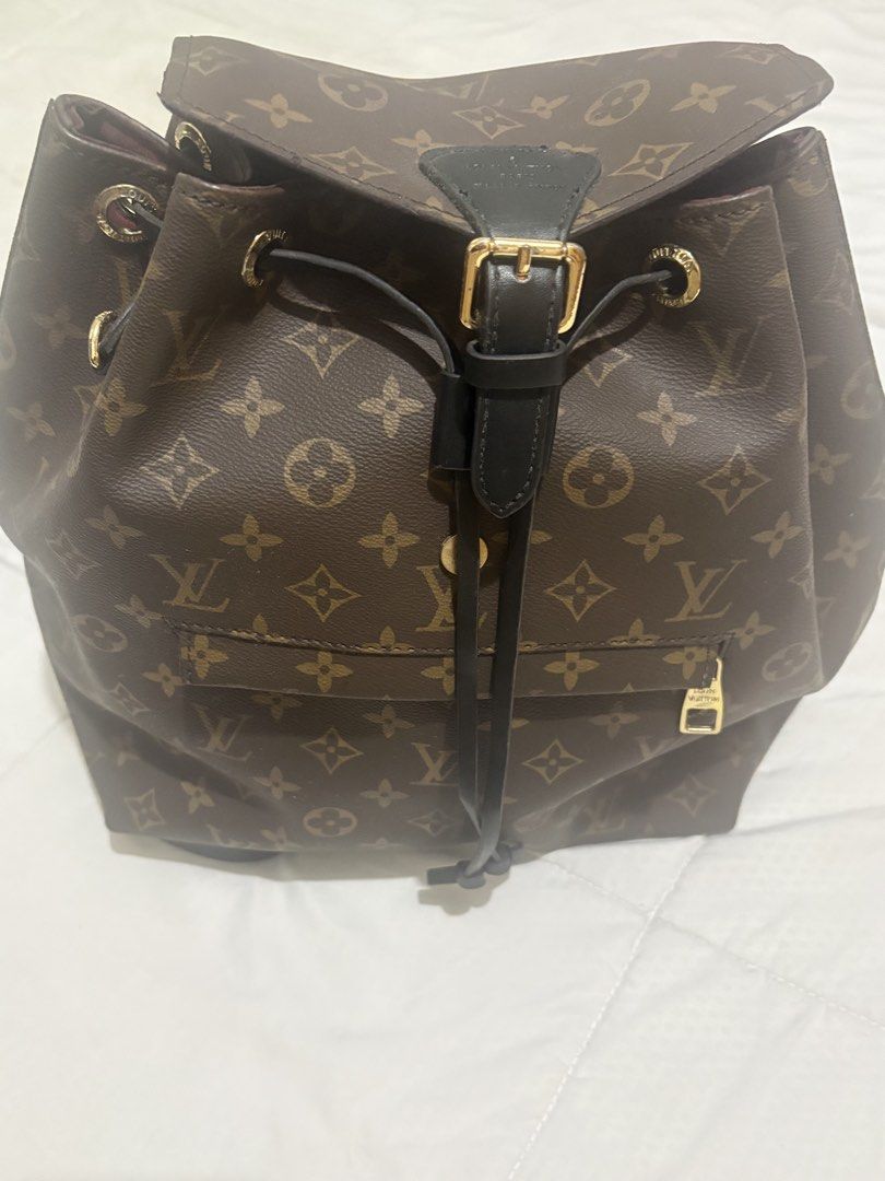 Louis Vuitton Monogram Canvas Backpack (Category: Luxury Bags & Wallets) located in Manila. Submitted by nykji96 (Listing ID 1469191182, Image 2). Description: - Authentic Louis Vuitton monogram canvas backpack - Stylish black leather straps and trim with gold-tone hardware - Secure drawstring closure with front buckle flap - Convenient exterior front zip pocket - Luxurious deep burgundy interior lining - Stamped Louis Vuitton Paris, Made in Fran
