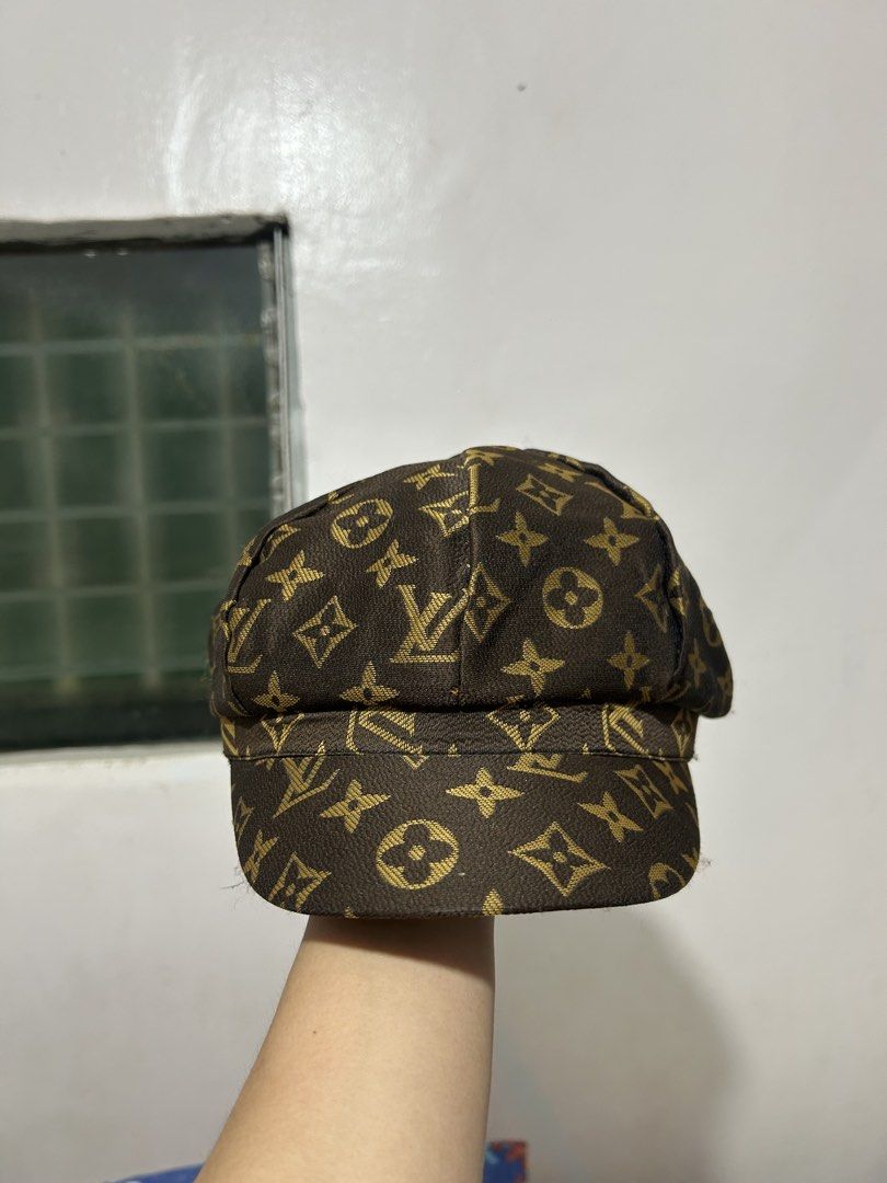 Louis Vuitton Monogram Newsboy Cap (Category: Caps & Hats) located in Quezon. Submitted by webtothecloset (Listing ID 1469217164, Image 2). Description: - Brand: Louis Vuitton ( Off ) - Style: Classic newsboy / baker boy cap - Pattern: Iconic gold-toned LV monogram on dark brown fabric - Design: Structured panels with a curved brim - Interior: Black satin lining with stitched LV brand tag - Condition: Excellent pre-loved condition - Mode of Payme