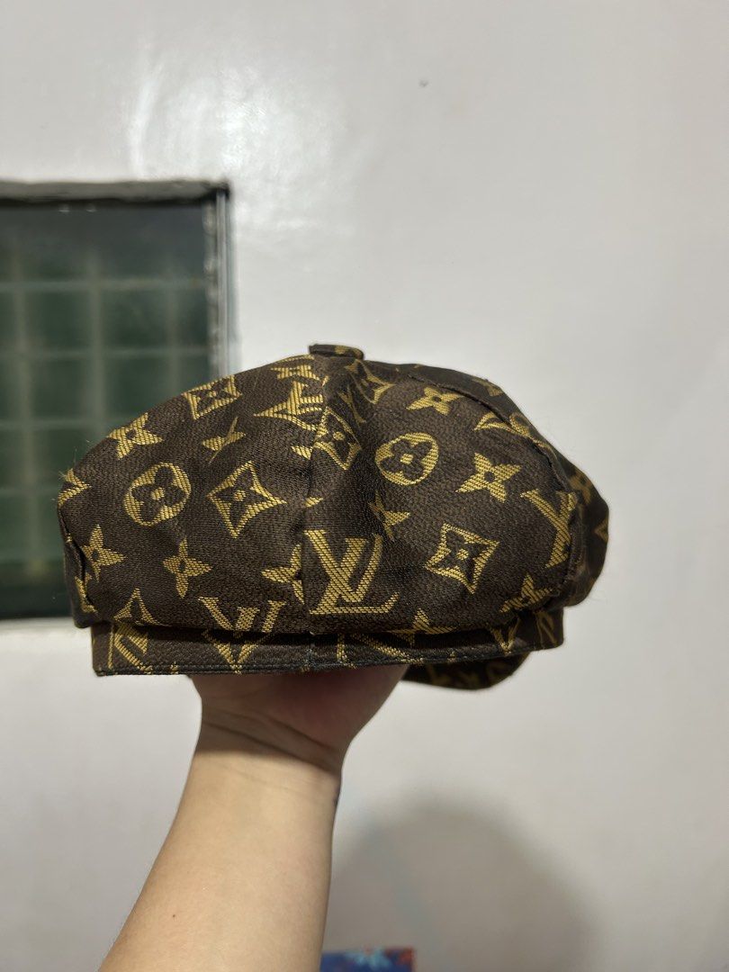 Louis Vuitton Monogram Newsboy Cap (Category: Caps & Hats) located in Quezon. Submitted by webtothecloset (Listing ID 1469217164, Image 3). Description: - Brand: Louis Vuitton ( Off ) - Style: Classic newsboy / baker boy cap - Pattern: Iconic gold-toned LV monogram on dark brown fabric - Design: Structured panels with a curved brim - Interior: Black satin lining with stitched LV brand tag - Condition: Excellent pre-loved condition - Mode of Payme