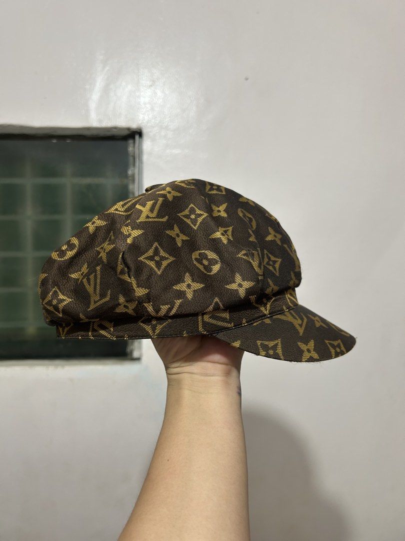 Louis Vuitton Monogram Newsboy Cap (Category: Caps & Hats) located in Quezon. Submitted by webtothecloset (Listing ID 1469217164, Image 1). Description: - Brand: Louis Vuitton ( Off ) - Style: Classic newsboy / baker boy cap - Pattern: Iconic gold-toned LV monogram on dark brown fabric - Design: Structured panels with a curved brim - Interior: Black satin lining with stitched LV brand tag - Condition: Excellent pre-loved condition - Mode of Payme