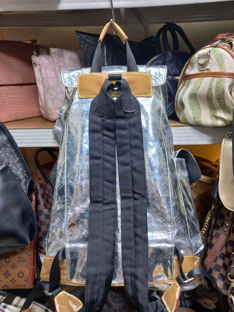 Louis Vuitton Silver Monogram Backpack (Category: Luxury Bags & Wallets) located in Manila. Submitted by del_thrifts03 (Listing ID 1469236737, Image 2). Description: - Style: Louis Vuitton Monogram Backpack - Color/Finish: Silver shiny finish with classic monogram pattern and tan canvas trim - Pockets: Convenient front flap pocket with stylish buckle straps - Straps: Comfortable black adjustable shoulder straps and top handle - Closure: Secure in