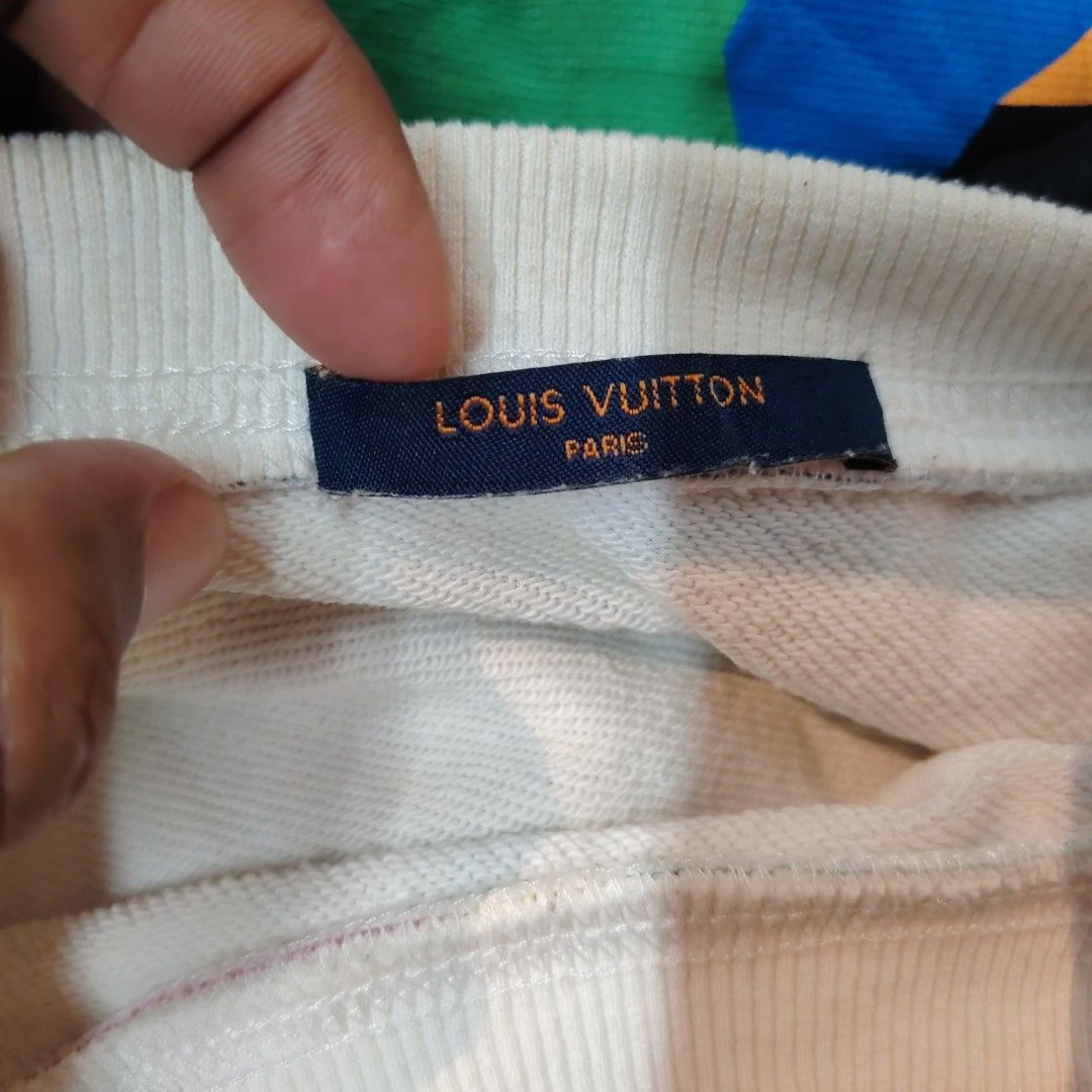 Louis Vuitton Watercolor Monogram Sweatshirt White Multi (Category: Luxury Apparel) located in Manila. Submitted by maetots (Listing ID 1469173931, Image 2). Description: - Brand: Louis Vuitton - Style: Crewneck sweatshirt - Color: White with multicolored watercolor monogram print - Design: Large pink LV logo across the chest - Material: Cotton blend French terry fabric - Details: Ribbed collar, cuffs, and hem; includes interior brand tags and Ja