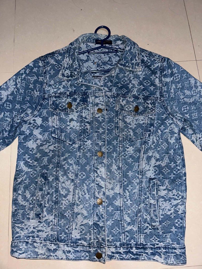 Louis Vuitton x Supreme Monogram Denim Trucker Jacket (Category: Coats, Jackets and Outerwear) located in Manila. Submitted by zna_onlineshop (Listing ID 1469237016, Image 1). Description: Louis Vuitton x Supreme denim jacket. All-over monogram pattern in washed blue. Classic button-up front, dual chest flap pockets, side welt pockets. Branded brass-tone hardware. Inside neck tag reads Louis Vuitton Paris. Leather patch detail stamped with LV and