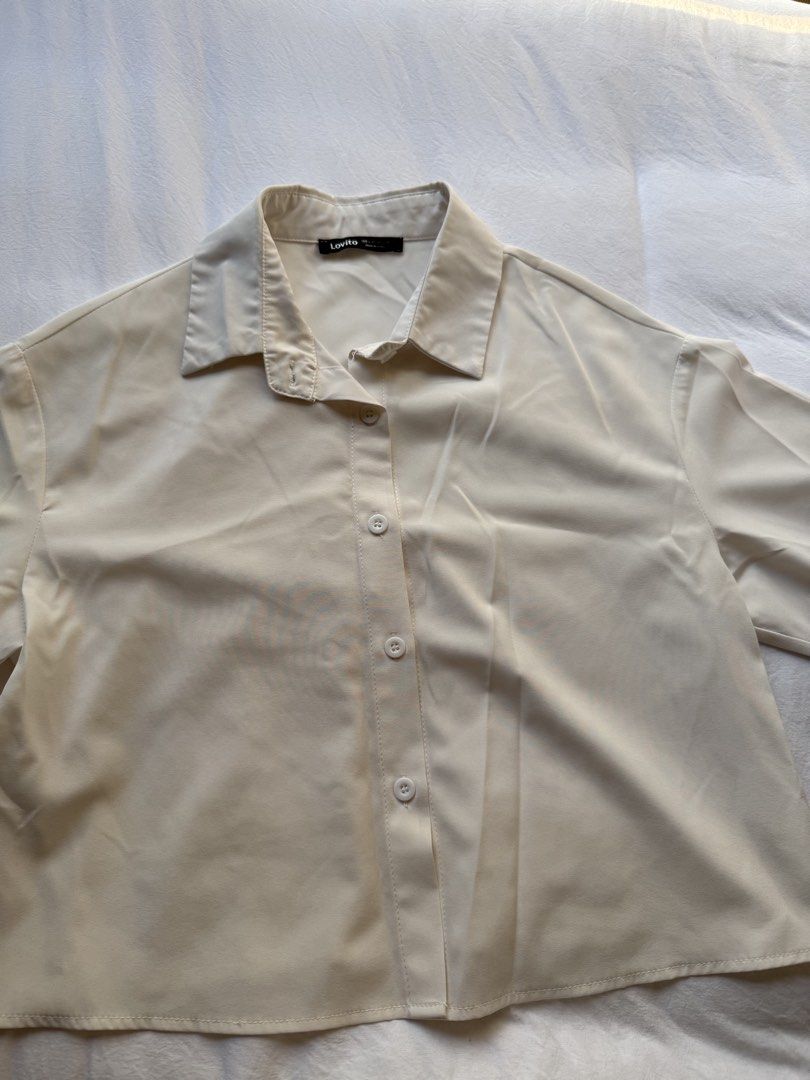 Lovito White Button-Up Collared Shirt (Category: Blouses) located in Manila. Submitted by the.prelovedcloset (Listing ID 1469255697, Image 1). Description: - Brand: Lovito - Color: Plain white - Style: Button-up shirt with classic collar and front button placket - Material: Lightweight and comfortable fabric - Size: EU 34 / US 4 - Condition: Clean, minimal wear, great everyday basic.