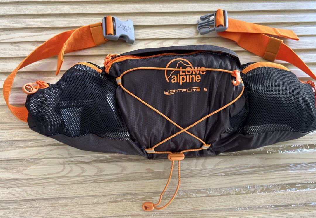 Lowe Alpine Lightflite 5 Waist Pack (Category: Belt bags, Clutches and Pouches) located in Cagayan de Oro. Submitted by aljay02 (Listing ID 1469295827, Image 3). Description: - Brand/Model: Lowe Alpine Lightflite 5 waist pack - Color: Black and Orange - Ideal for: Running, hiking, and outdoor workouts - Features: Front bungee cord system for extra gear, secure mesh side pockets for bottles - Fit: Adjustable waist strap with sturdy buckle closure 
