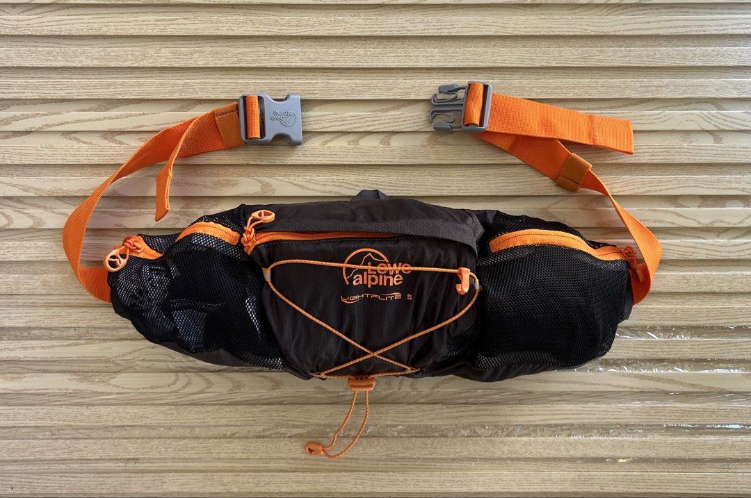 Lowe Alpine Lightflite 5 Waist Pack (Category: Belt bags, Clutches and Pouches) located in Cagayan de Oro. Submitted by aljay02 (Listing ID 1469295827, Image 2). Description: - Brand/Model: Lowe Alpine Lightflite 5 waist pack - Color: Black and Orange - Ideal for: Running, hiking, and outdoor workouts - Features: Front bungee cord system for extra gear, secure mesh side pockets for bottles - Fit: Adjustable waist strap with sturdy buckle closure 