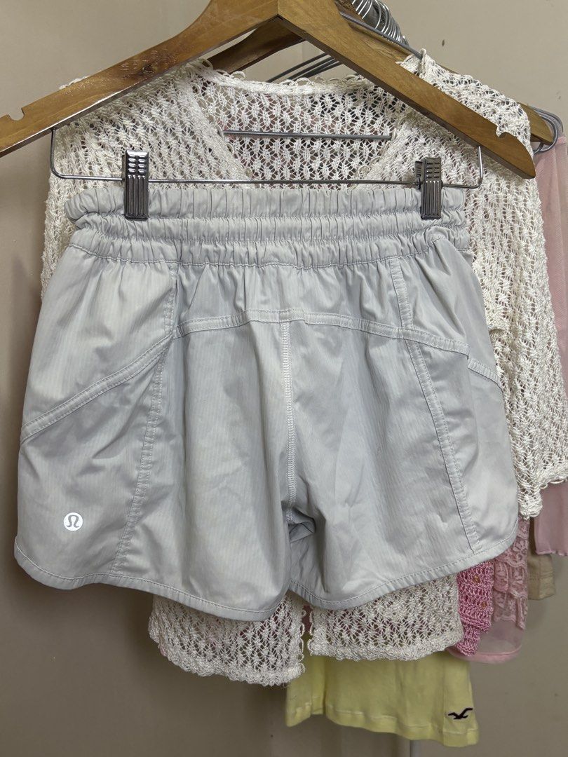 Lululemon Athletic Shorts Light Grey with Zip Pocket (Category: Shorts) located in Ajuy. Submitted by galitsabarat (Listing ID 1469276848, Image 1). Description: - Brand: Lululemon - Color: Light grey with a subtle striped texture - Waistband: Elastic with a cute ruffled top edge - Pocket: Convenient side zipper pocket with logo pull tab - Logo: Classic Lululemon omega logo on the back lower hem - Material: Lightweight, breathable, and easy to mo