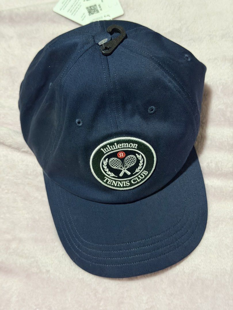 Lululemon Cap (Category: Caps & Hats) located in Makati City. Submitted by xoxonisse (Listing ID 1469337294, Image 1). Description: - Brand: Lululemon - Item: Tennis Club Cap - Color: Dark Navy Blue - Size: S/M - Condition: Brand new with original store tags - Details: Embroidered tennis club patch on front, 'Meet You Courtside' lettering on back, adjustable strap with silver metal buckle.