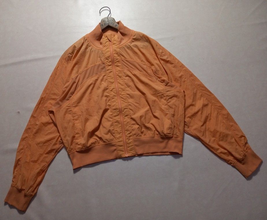 Lululemon Orange Reflective Lululemon Logo Zip-Up Bomber Jacket Authentic (Category: Coats, Jackets and Outerwear) located in Urdaneta. Submitted by josephragontonjr95 (Listing ID 1469191191, Image 3). Description: - Lululemon Orange Reflective Lululemon Logo Zip-Up Bomber Jacket Authentic - SIZE: 10 - DIMENSIONS ⬇️ ⬇️ ⬇️ - WIDTH: 22 - LENGTH: 21 - COLOR RATE: 9.8/10 - ISSUES/FLAWS: 2 DOT STAINS - CONDITION: EXCELLENT - Style: Zip-up bomber jacke