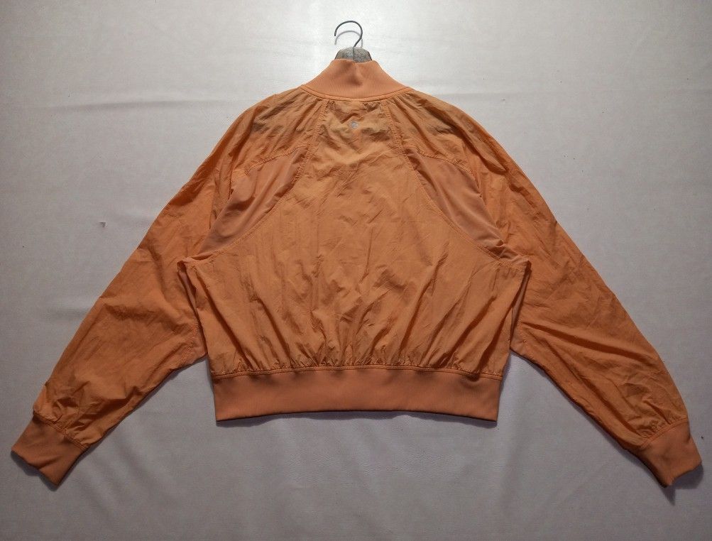 Lululemon Orange Reflective Lululemon Logo Zip-Up Bomber Jacket Authentic (Category: Coats, Jackets and Outerwear) located in Urdaneta. Submitted by josephragontonjr95 (Listing ID 1469191191, Image 2). Description: - Lululemon Orange Reflective Lululemon Logo Zip-Up Bomber Jacket Authentic - SIZE: 10 - DIMENSIONS ⬇️ ⬇️ ⬇️ - WIDTH: 22 - LENGTH: 21 - COLOR RATE: 9.8/10 - ISSUES/FLAWS: 2 DOT STAINS - CONDITION: EXCELLENT - Style: Zip-up bomber jacke