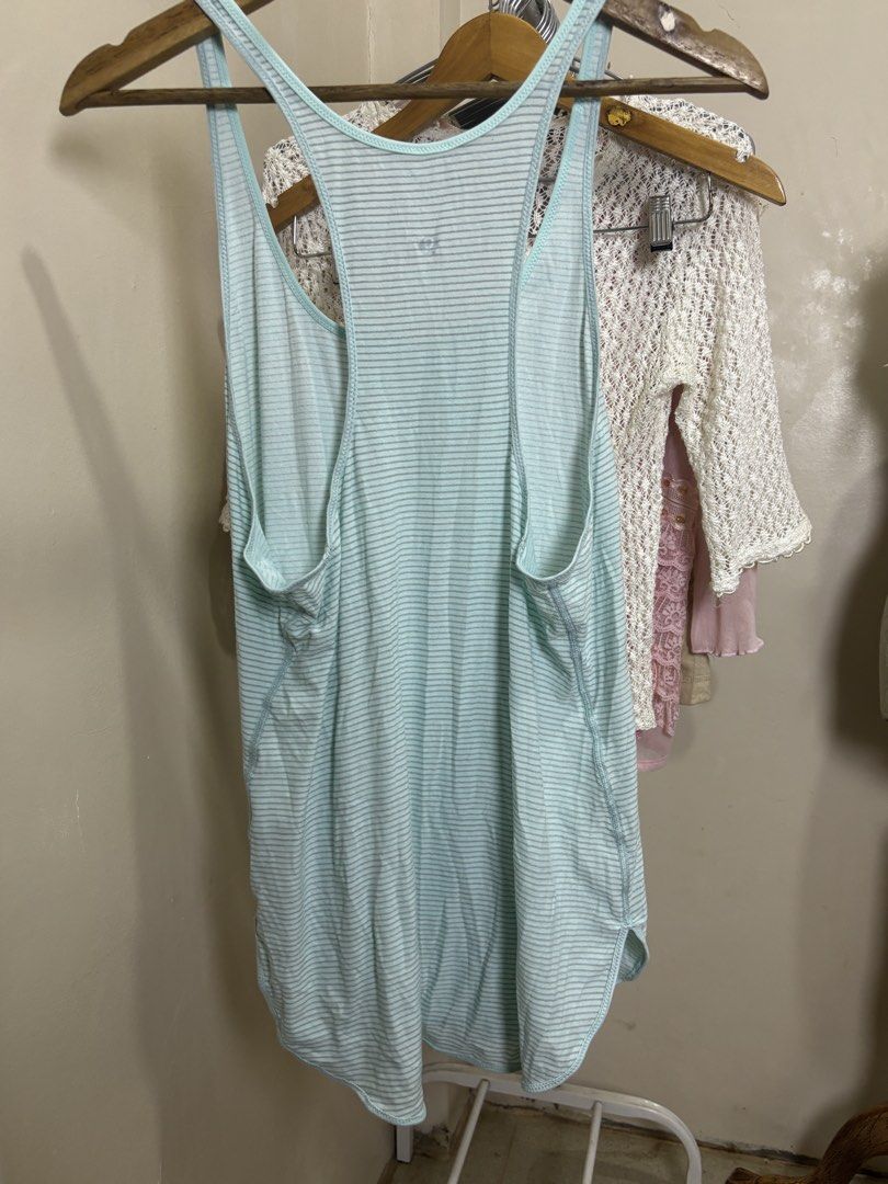 Lululemon Striped Athletic Tank Top (Category: Activewear) located in Ajuy. Submitted by galitsabarat (Listing ID 1469292882, Image 2). Description: - Brand: Lululemon - Design: Light blue & white stripes with a racerback and rounded hem - Material: Lightweight & breathable fabric, ideal for workouts or casual days - Details: Contrast stitching & iconic silver omega logo on the back - Mode of Payment: GCash, BPI, or COD - Shipping: Via J&T or Sam