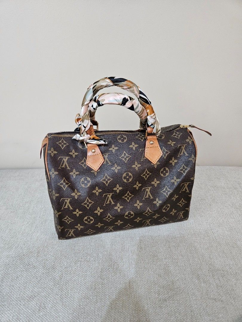 LV Monogram Speedy (Category: Luxury Bags & Wallets) located in Quezon City. Submitted by andyrms (Listing ID 1469208205, Image 1). Description: - Bought in Japan - Brown coated canvas with LV print and vachetta leather trim - Secure zip closure with classic gold-tone hardware - Clean interior fabric lining with structured shape - Date code: SP0028 stamped inside - Comes with a stylish twilly scarf wrapped around the top handles - Perfect timeles