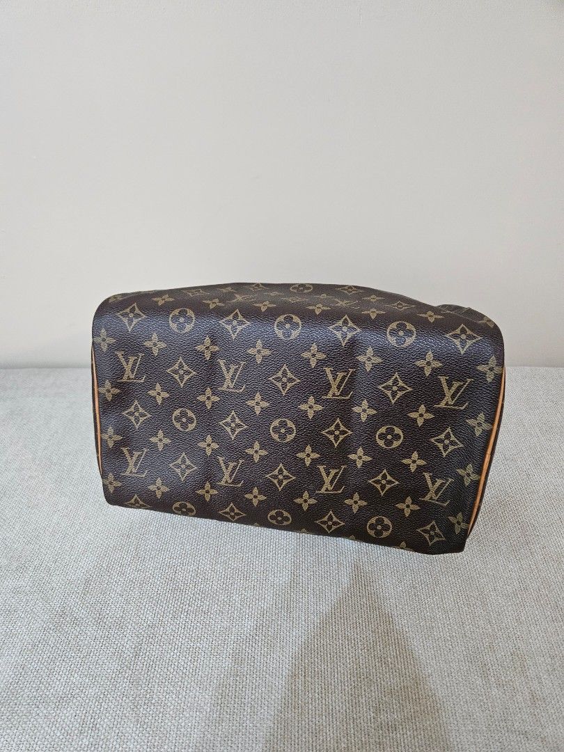 LV Monogram Speedy (Category: Luxury Bags & Wallets) located in Quezon City. Submitted by andyrms (Listing ID 1469208205, Image 2). Description: - Bought in Japan - Brown coated canvas with LV print and vachetta leather trim - Secure zip closure with classic gold-tone hardware - Clean interior fabric lining with structured shape - Date code: SP0028 stamped inside - Comes with a stylish twilly scarf wrapped around the top handles - Perfect timeles