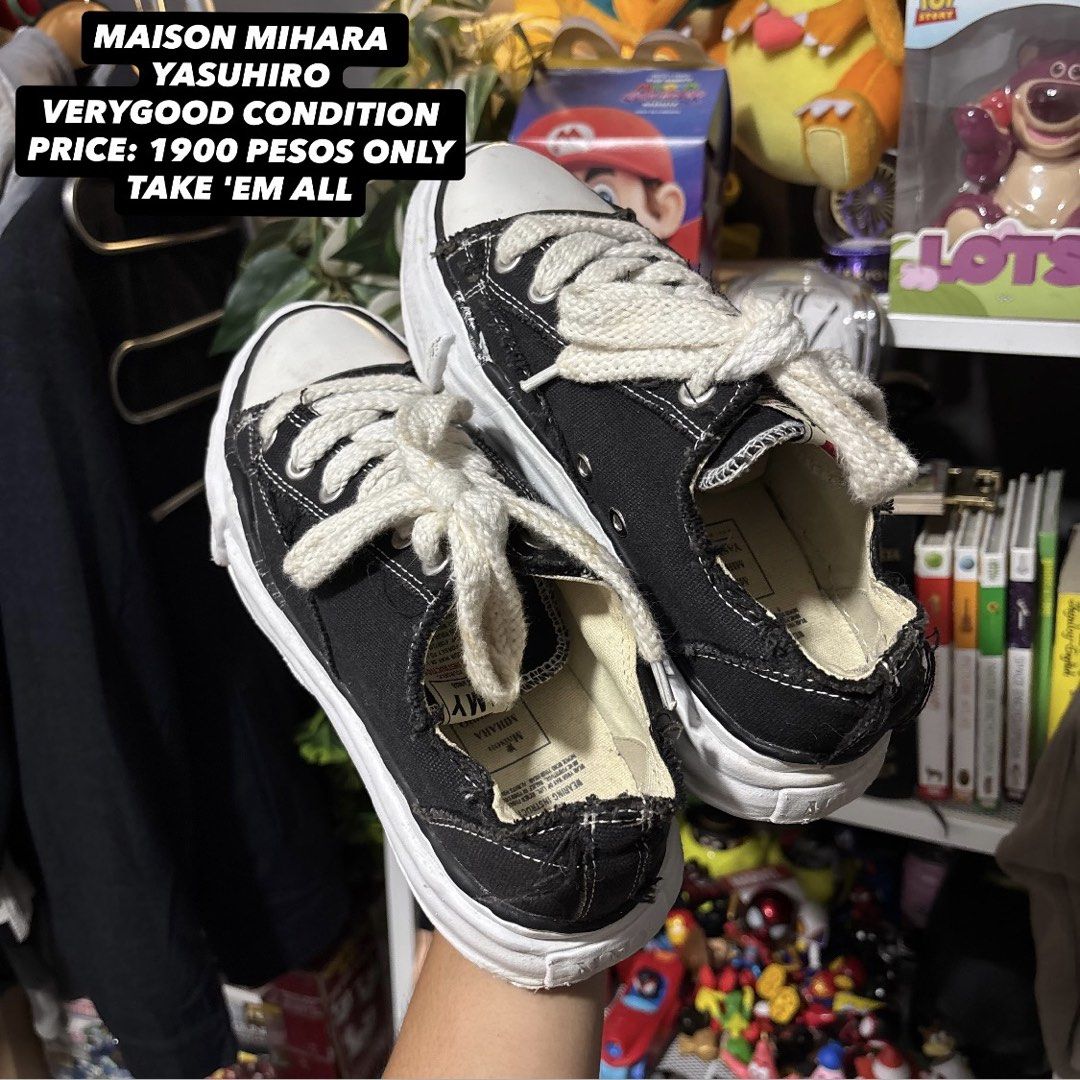 Maison Mihara Yasuhiro Black Low Top Sneakers (Category: Sneakers) located in Caloocan City. Submitted by bonsatocha43876 (Listing ID 1469312701, Image 1). Description: - Brand: Maison Mihara Yasuhiro - Color/Material: Classic black canvas - Design: Distinctive chunky distorted white sole, thick cream laces, and edgy raw frayed details - Condition: Very good overall - Price: ₱1,900 only.