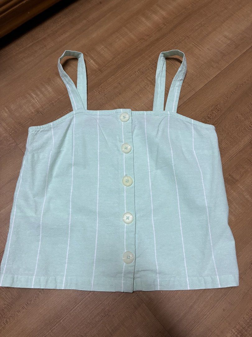 Mango Mint Green Striped Button-Front Cami Crop Top (Category: Sleeveless) located in Quezon City. Submitted by habits.mnl (Listing ID 1469235061, Image 1). Description: Xs on tag fits small - Color: Mint green with thin white vertical stripes - Style: Crop top with straight neckline and button-down front - Details: Matching light-colored buttons and thick shoulder straps - Material: Lightweight fabric, ideal for warm weather - Condition: Clean a